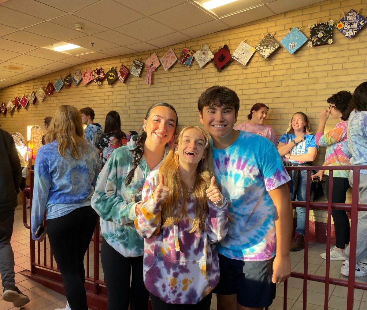 Left to right: Ava Augusto, Lexi Urban, and Jack Favata celebrate tye dye day.